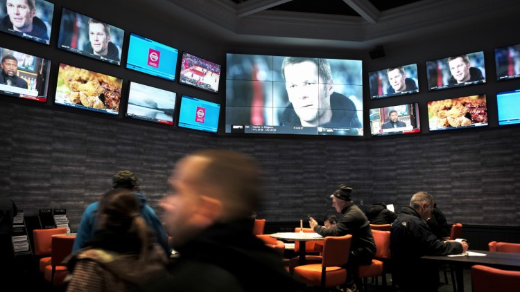 Patrons mill about at the sports betting area of Twin River Casino in Lincoln, R.I., but expect the crowds to be thick on Sunday when fans of the New England Patriots can place legal bets on the Super Bowl.