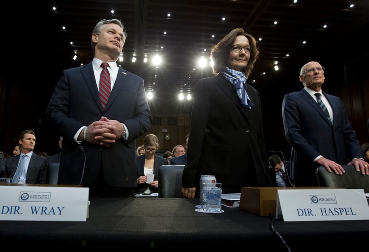 From left, FBI Director Christopher Wray, CIA Director Gina Haspel and Director of National Intelligence Daniel Coats arrive to testify before the Senate Intelligence Committee on Tuesday. 