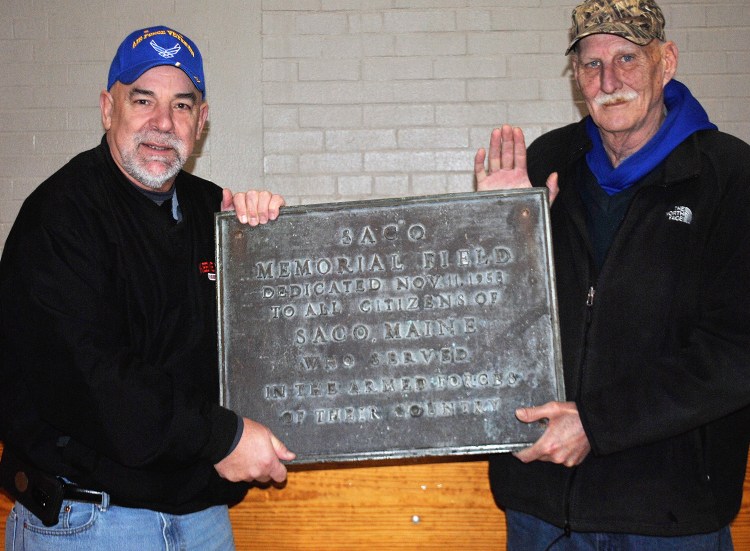 Ron Kendall and Marty Feery of Wethersfield, Connecticut, hold the sign they returned to Saco at the Saco Community Center on Tuesday.
