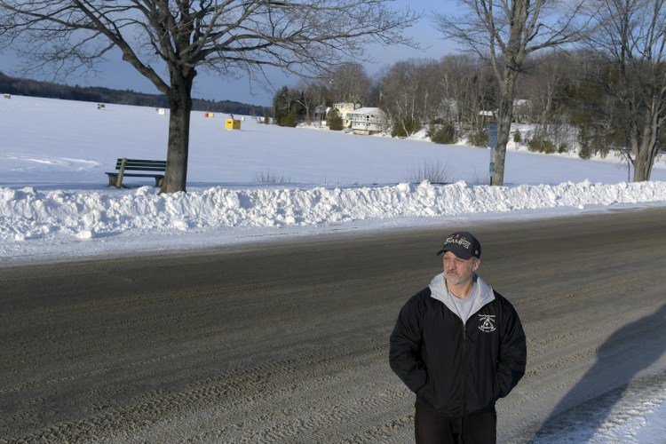 Ryan Chamberland stands near his home Thursday on Memorial Drive in Winthrop. He said the road along Maranacook Lake is deteriorating and the town is not maintaining it properly.