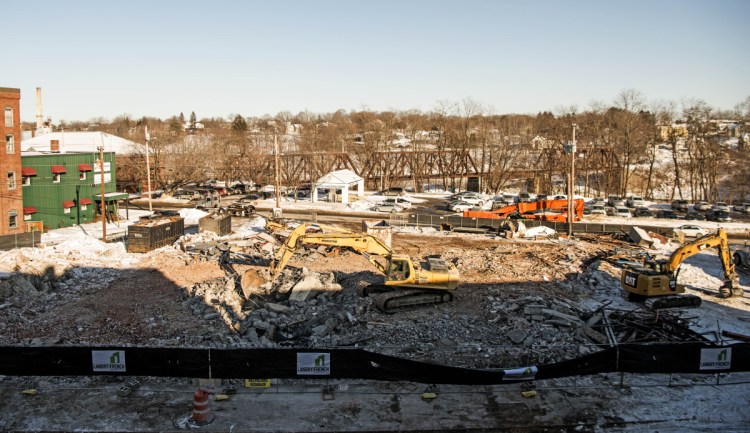 Rubber and an excavator remain on Friday where the old Camden National Bank building once stood on Main Street in downtown Waterville. The space is being cleared for construction of a new boutique hotel.