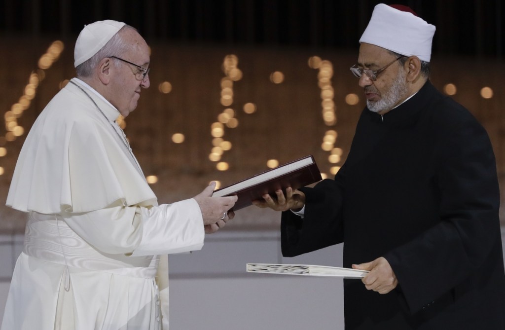 Pope Francis and Sheikh Ahmed el-Tayeb, the grand imam of Egypt's Al-Azhar, exchange a joint statement on "human fraternity" after an interfaith meeting at the Founders' Memorial in Abu Dhabi, United Arab Emirates, Monday.