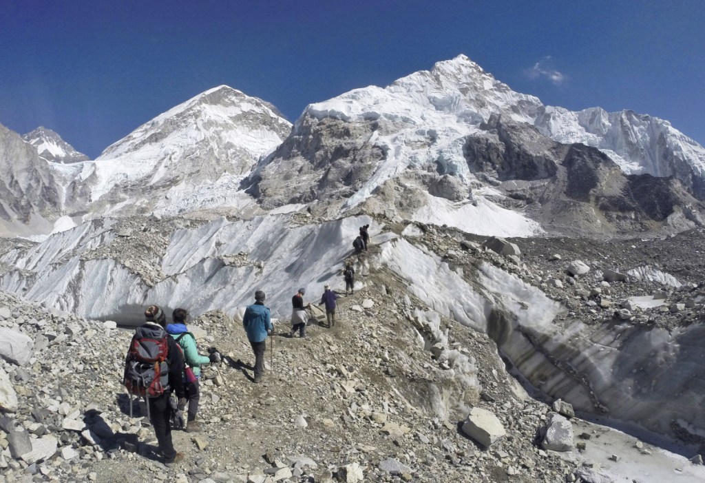 Trekkers pass through a glacier at the Mount Everest base camp, Nepal, on Feb. 22, 2016. A study reported one-third of Himalayan glaciers will melt by the end of the century due to climate change.