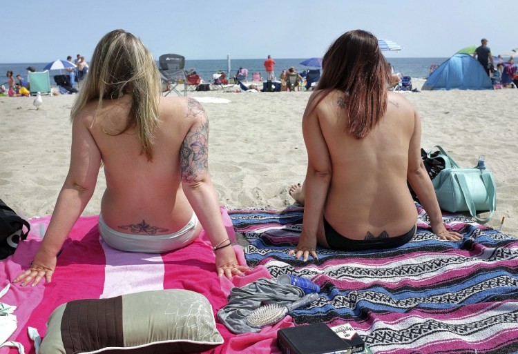 Women go topless as they participate in the Free the Nipple global movement during Go Topless Day at Hampton Beach, N.H. in 2017.