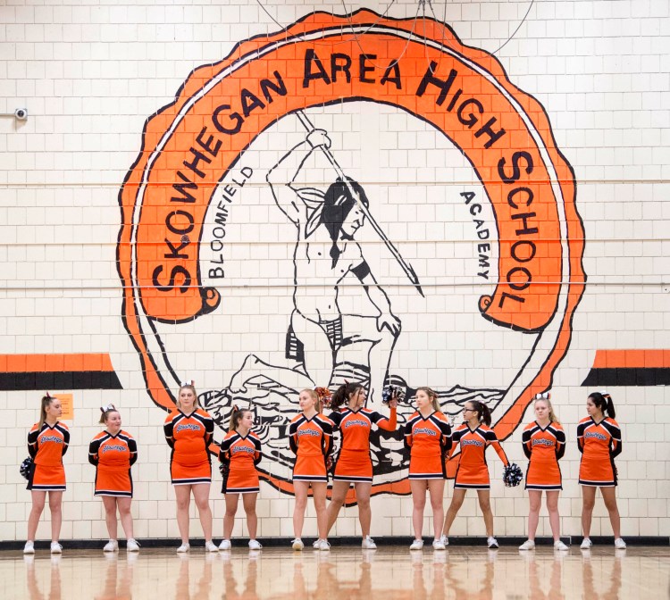 Skowhegan Area High School cheerleaders stand beneath the Indian mural on the wall of the gymnasium on Jan. 15.