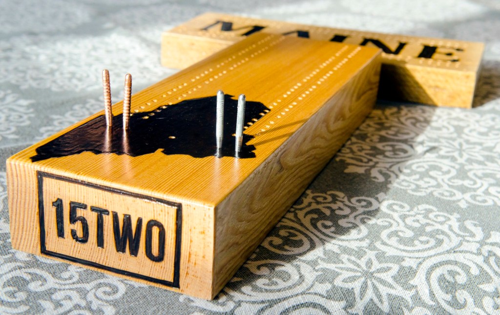 William Terry wood-burns his handmade cribbage boards with the 15TWO brand name Feb. 2 in Richmond.