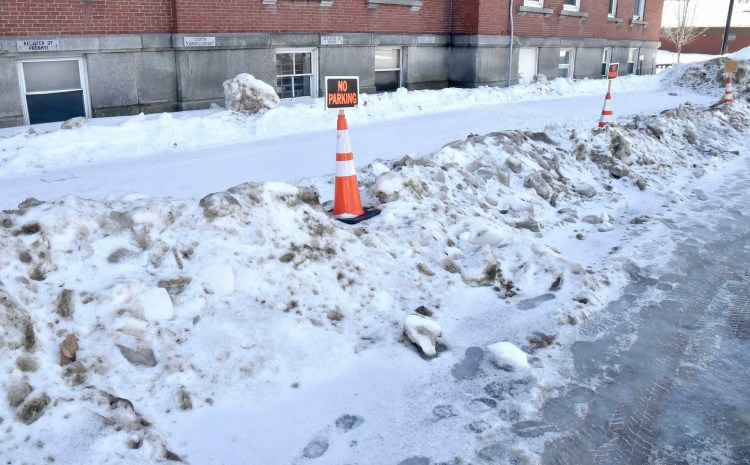 Snow slid off the roof of the Court House in Skowhegan, and was blocking parking spots Tuesday for commissioners, administrators and jail transport vehicles.