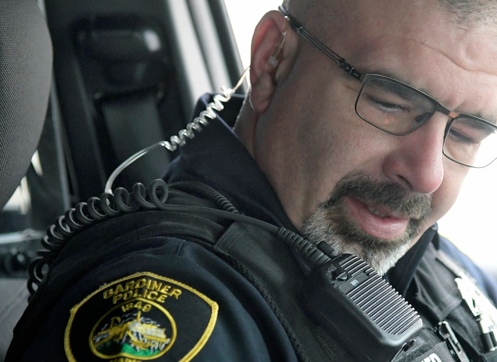 Gardiner police Officer Marcus Niedner wears an earpiece and microphone to respond to radio calls on Feb. 7.