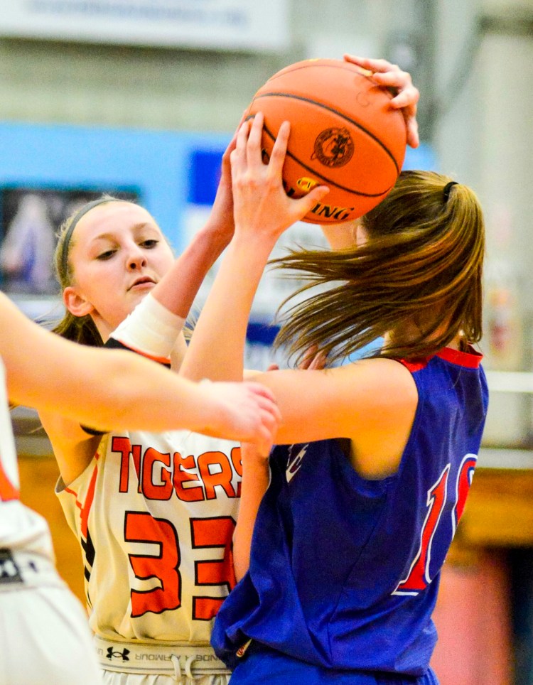 Gardine's Bailey Poore, left, and Messalonskee's Kaitlin Seekins battle for a rebound during a Class A North quarterfinal game Friday at the Augusta Civic Center. 