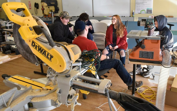 Cornville Regional Charter School students in the Tech Safety class, including Hailey Pelletier, center, take a break Feb. 11 near new building equipment at the school's downtown Skowhegan property.