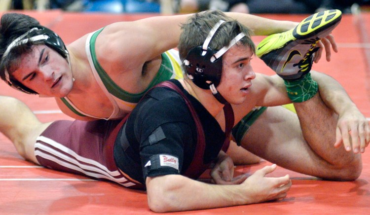 Massabesic's Matthew Pooler, top, tries to pin down Nokomis' David Wilson in  the 170-pound finals at the Class A state championships Saturday at Cony High School in Augusta. 