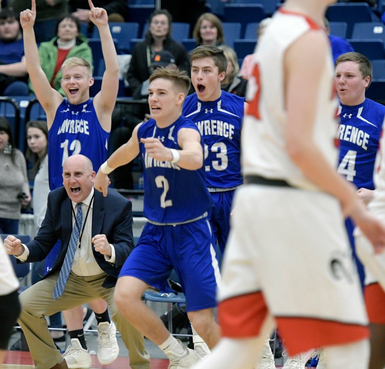 Lawrence High School's bench erupts after defeating Cony High School during a tournament basketball game on Wednesday at the Augusta Civic Center.