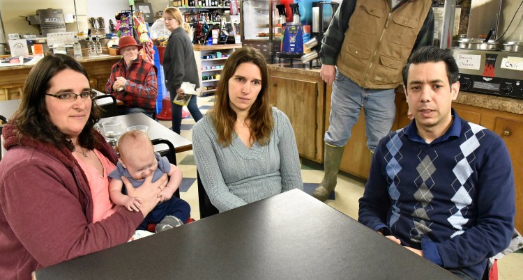 Former Athens Corner Store owners Katie Anton, with son Matthew, and Stephanie Miller sit with current store manager Alex Rehman on Tuesday and discuss the recent sale of the town landmark.