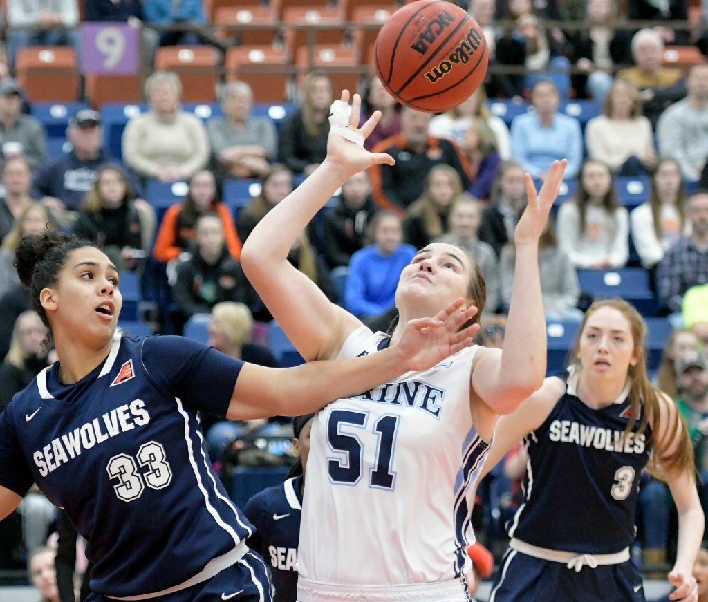 The University of Maine's Fanny Wadling collects a rebound from State University of New York at Stony Brook's India Pagan during a basketball game Sunday at the Augusta Civic Center.