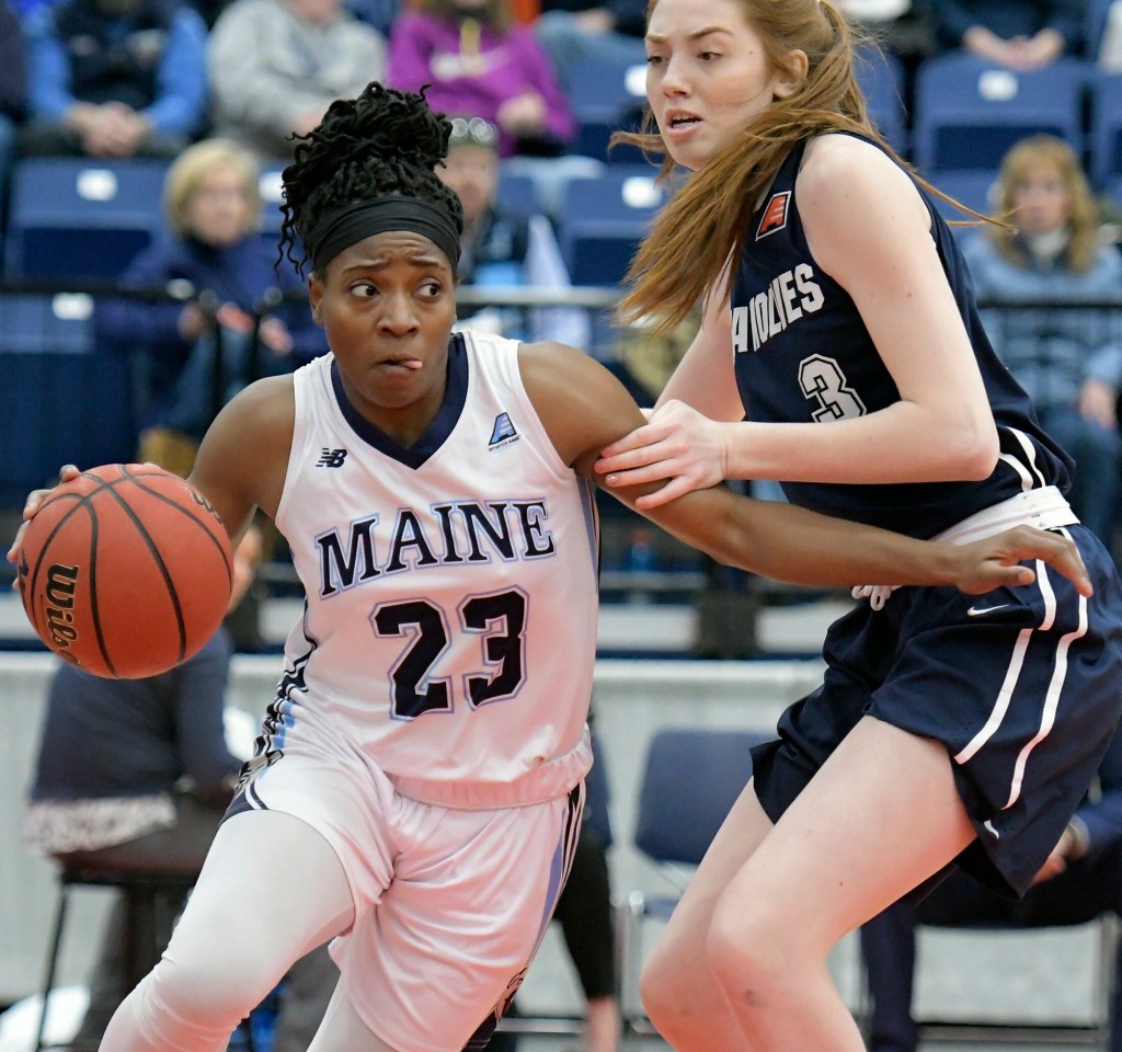 The University of Maine's Tanesha Sutton dribbles around State University of New York at Stony Brook's Oksana Gouchie-Provencher during a basketball game Sunday at the Augusta Civic Center.