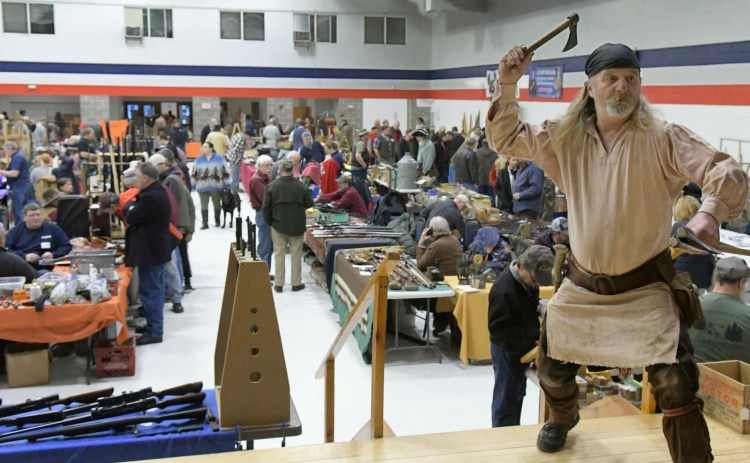 Ancient Ones member Dave Bryant, of Mount Vernon, hurls tomahawks Sunday during the group's gun show in Augusta.