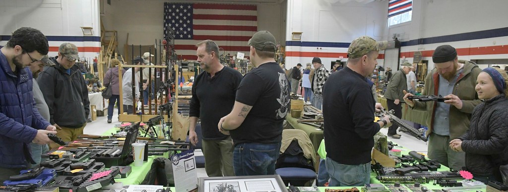 Guests browse Sunday among firearms and supplies at the Ancient Ones show in Augusta.