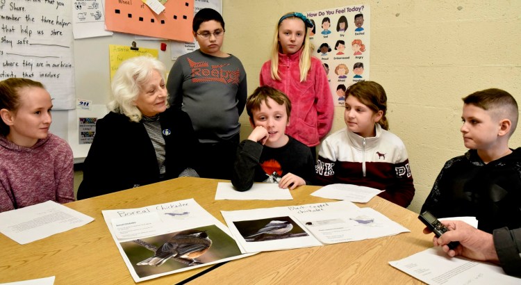 Margaret Chase Smith student Jasiah Marshall, center, explains why he would like the boreal chickadee, image at left, to be officially named the Maine state bird on Monday. Students in the fourth grade wrote letters that will accompany state Rep. Betty Austin when she proposes the law this week in Augusta. From left are Faith Pease, Austin, Thomas Gage, Marshall, Addie Bubier, Emilee Kirby and Evan Goodridge. 