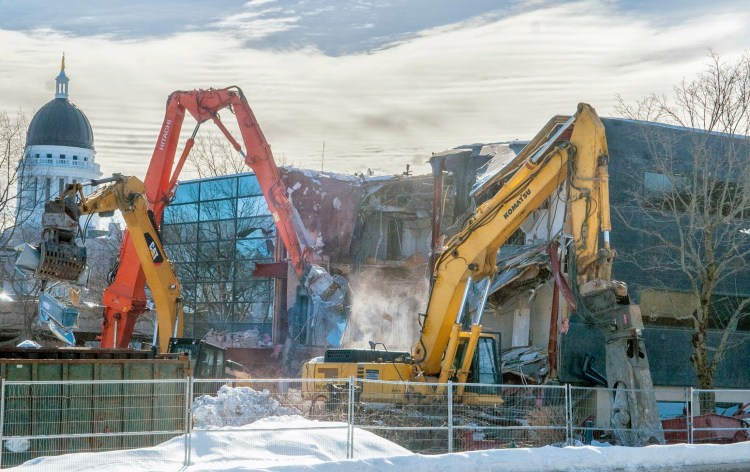 Excavators tear apart the old Maine Public Employees Retirement System building on Wednesday at the corner of Sewall and Capitol streets near the Maine State House in Augusta.