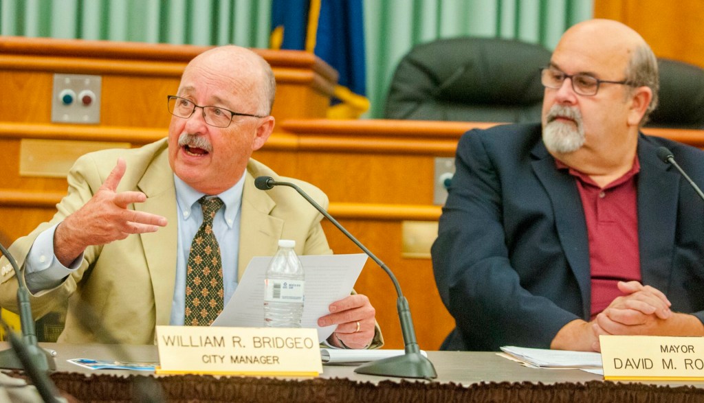 City Manager William Bridgeo speaks in July 2017 at a City Council meeting at City Center in Augusta. At right, Mayor David Rollins. Kennebec Journal file photo by Joe Phelan