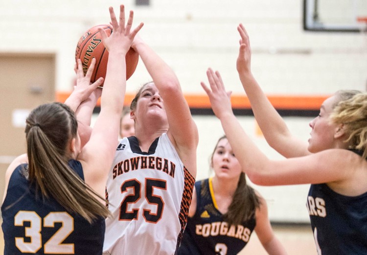 Skowhegan senior Sydney Ames (25) drives to the hoop as Mt. Blue defender Jacelyn Daggett closes in during a Jan. 15 game.