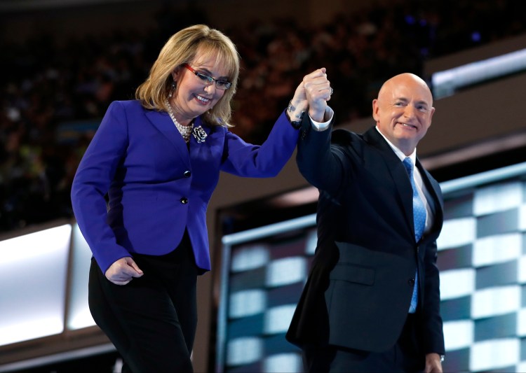 Former Rep. Gabby Giffords, D-Ariz., and her husband Astronaut Mark Kelly (ret.), walk off the stage after speaking during the third day of the Democratic National Convention in Philadelphia, Wednesday, July 27, 2016. 