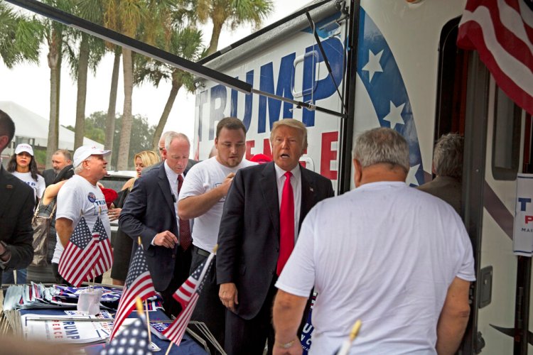 A woman is alleging in a new lawsuit filed Monday, Feb. 25, 2019, that Inside the RV seen here, Trump kissed a member of his campaign staff without consent. The woman, Alva Johnson, can be seen in the background of this photo wearing a Trump shirt and a hat on the left side of the frame.