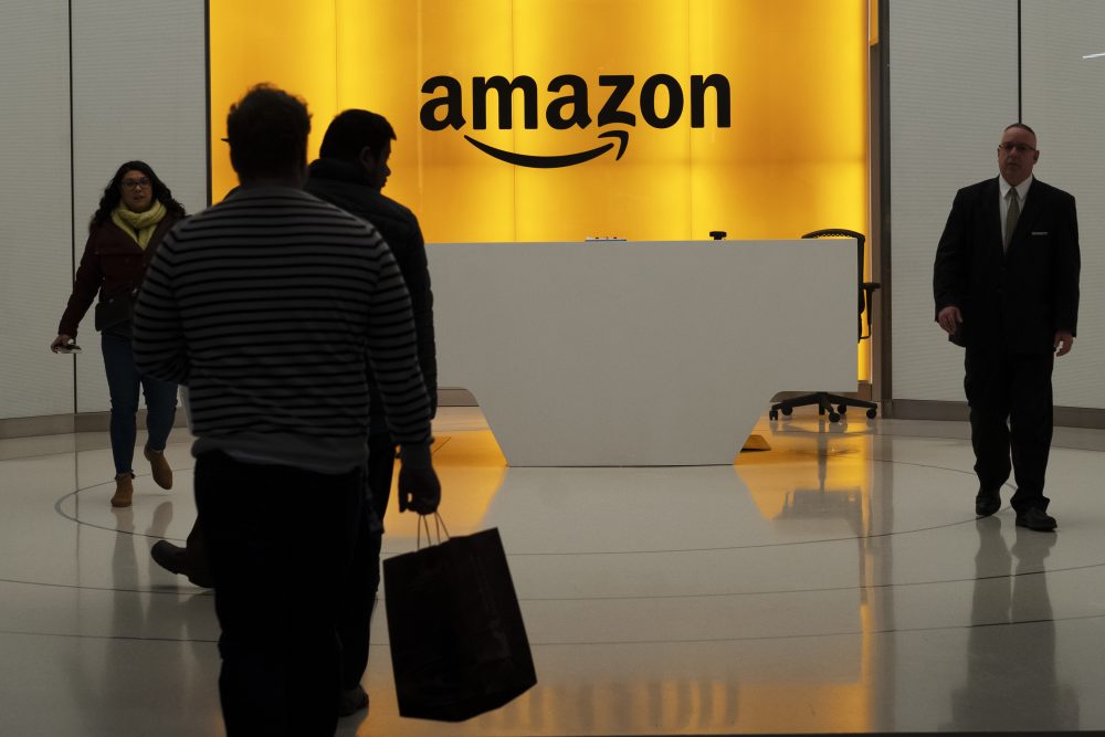 People walk into the lobby for Amazon offices Thursday, Feb. 14, 2019, in New York. Amazon will not build a new headquarters in New York City, a stunning reversal to an ambitious plan that would have brought an estimated 25,000 jobs to the city. (AP Photo/Mark Lennihan)