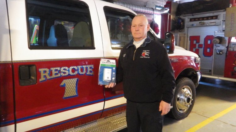 Rumford Fire Chief Chris Reed holds a carbon monoxide detector, which he says people must have to protect themselves from a gas that is colorless, odorless and deadly. 