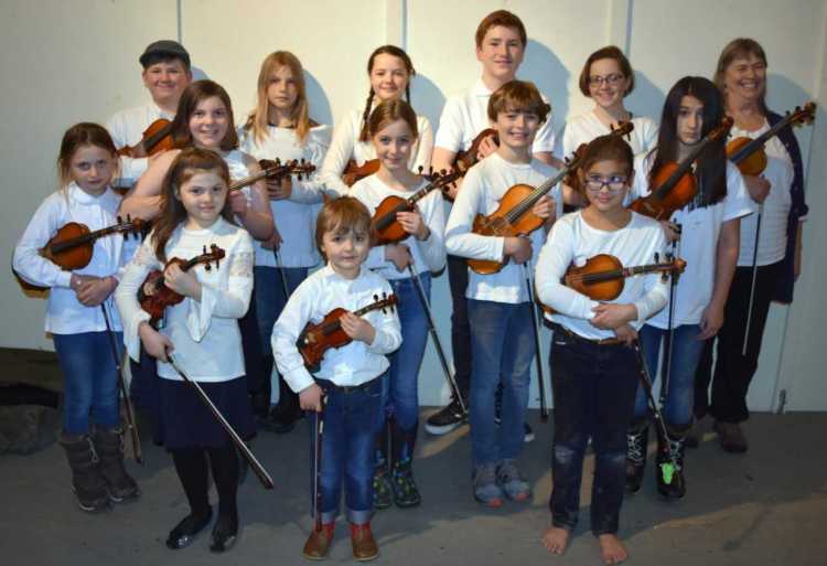 Pineland Fiddlers front from left are Mary Philbrick, Silas Edwards and Victoria Hahn. Second row from left are Cora Welling, Allison Philbrick, Nori Edwards, Caleb Edwards and Amelie Hahn. Back from left are Owen Kennedy, Beck Welling, Lily Scease-Drouin, Elijah Huttman, Camila Ciembroniewicz, and Ellen Gawler.