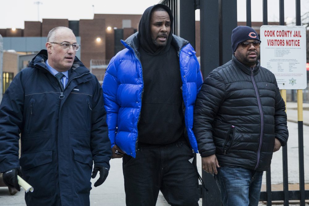 R. Kelly, center, walks out of Cook County Jail with his defense attorney, Steve Greenberg, left, after posting $100,000 bail, Monday afternoon, Feb. 25, 2019, in Chicago. The R&B star walked out of a Chicago jail Monday after posting $100,000 bail that will allow him to go free while awaiting trial on charges that he sexually abused four people dating back to 1998, including three underage girls. (Ashlee Rezin/Chicago Sun-Times via AP)