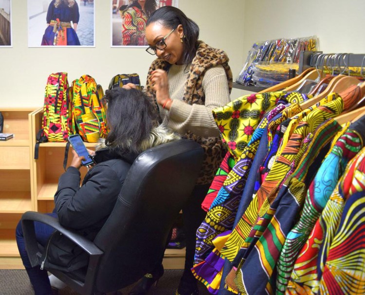 NanuSka Style owner Nana Batumike braids Alice Umulisa's hair last week in her rented space in Fikiria. Batumike pays below-market rent and gets business guidance and advice to help her get started.