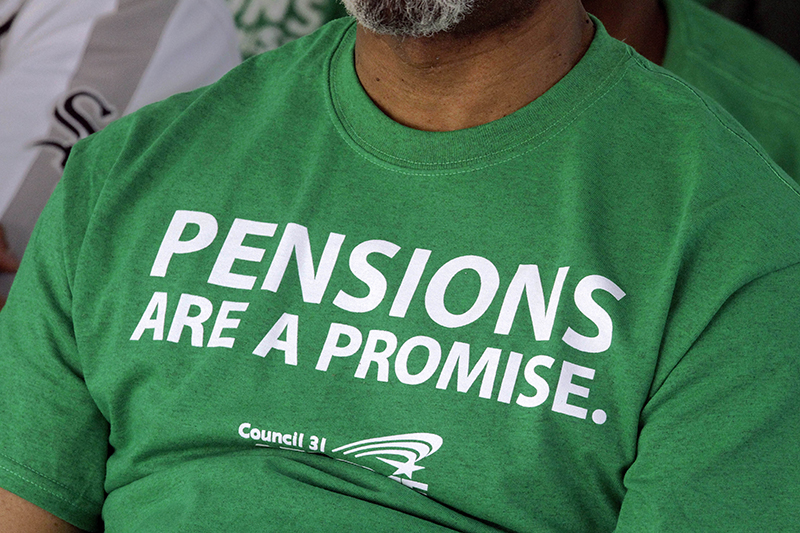 In this photo taken May 2012 an American Federation of State County and Municipal Employees union member wears their protest message on his shirt while rallying against the proposed pension legislation at the Illinois State Capitol in Springfield, Ill. The Pew Center on the States releases a 50-state report that finds the gap between the promises states have made for public employees’ retirement benefits and the money they have set aside has grown. (AP Photo/Seth Perlman)
