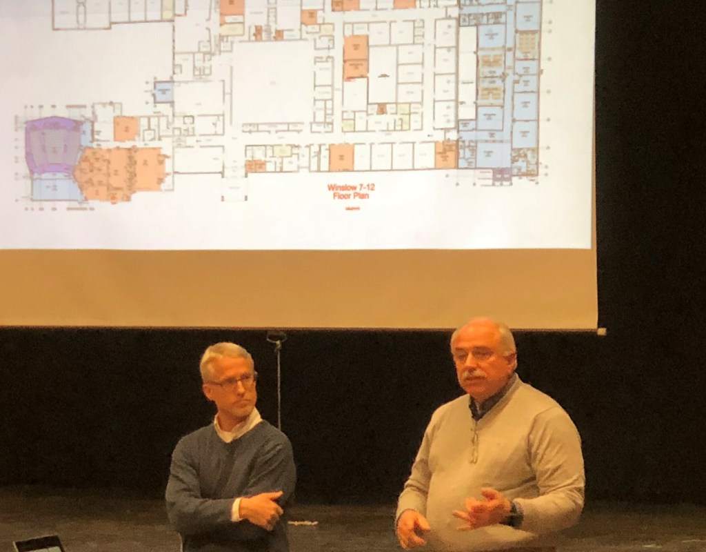 On Tuesday night, architect Doug Breer, left, and construction manager Peter Pelletier show plans for the Winslow school renovation plan that could reduce the project's budget overage. 