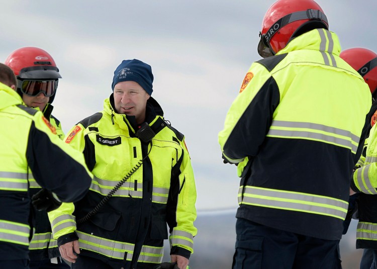 Donald Genest, center, confers with fellow firefighters during snowmobile training Feb. 21 at the Augusta Fire Department's north station in Augusta.