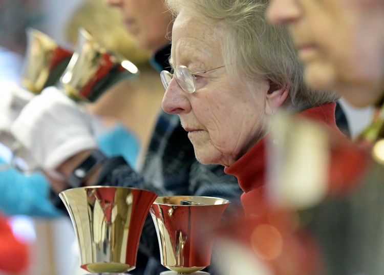 Lee Gilman, 84, rehearses ringing bells with other members of the Winthrop Area Handbell Ringers on Feb. 21 in Winthrop.