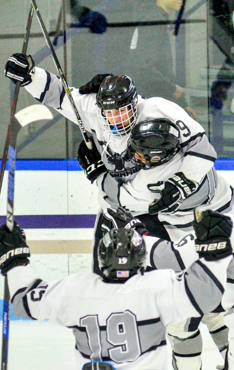 Kennebec's Nathan Newgard, top, celebrates with teammates after scoring a first-period goal against Presque Isle during a Class B North semifinal last season at Colby College in Waterville. 