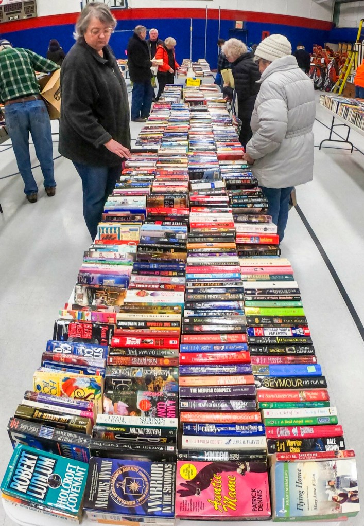 Shoppers browse among the tables Saturday during the Friends of the Belgrade Library book sale in the Belgrade Central School gymnasium.