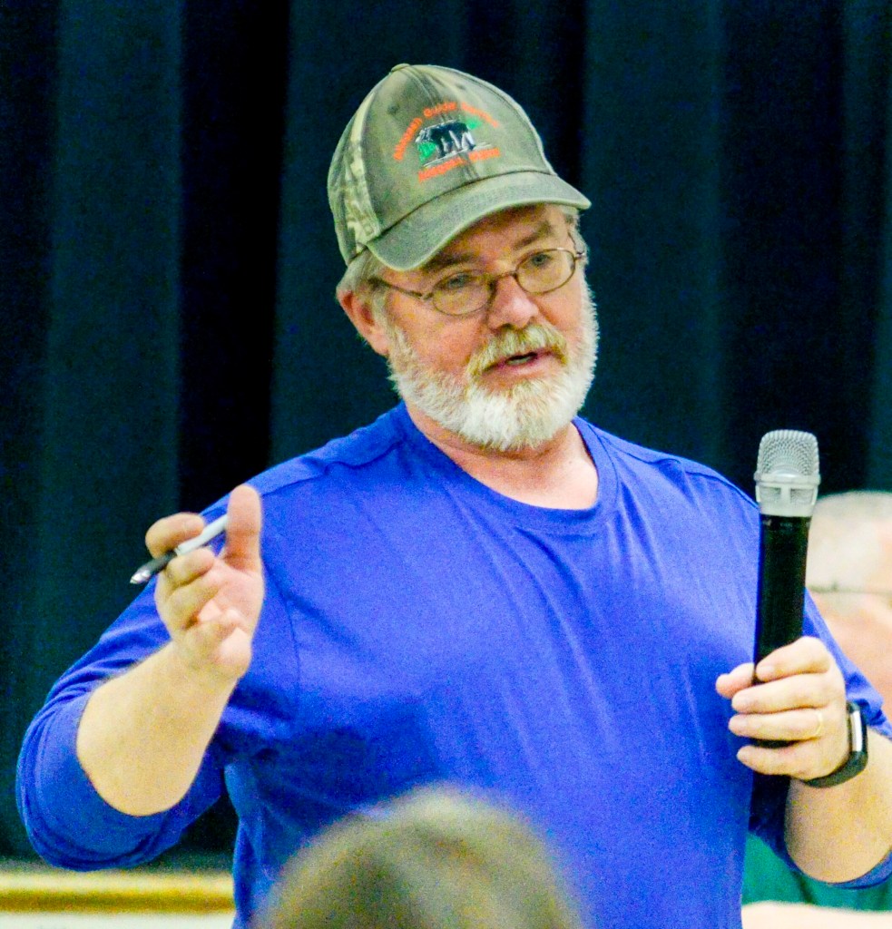 Anson Road Commissioner Arty Lane answers questions during debate Saturday on article about whether to repair a town plow truck. The debate occurred at the Anson Town Meeting, which was held in the Carrabec High School gymnasium. 