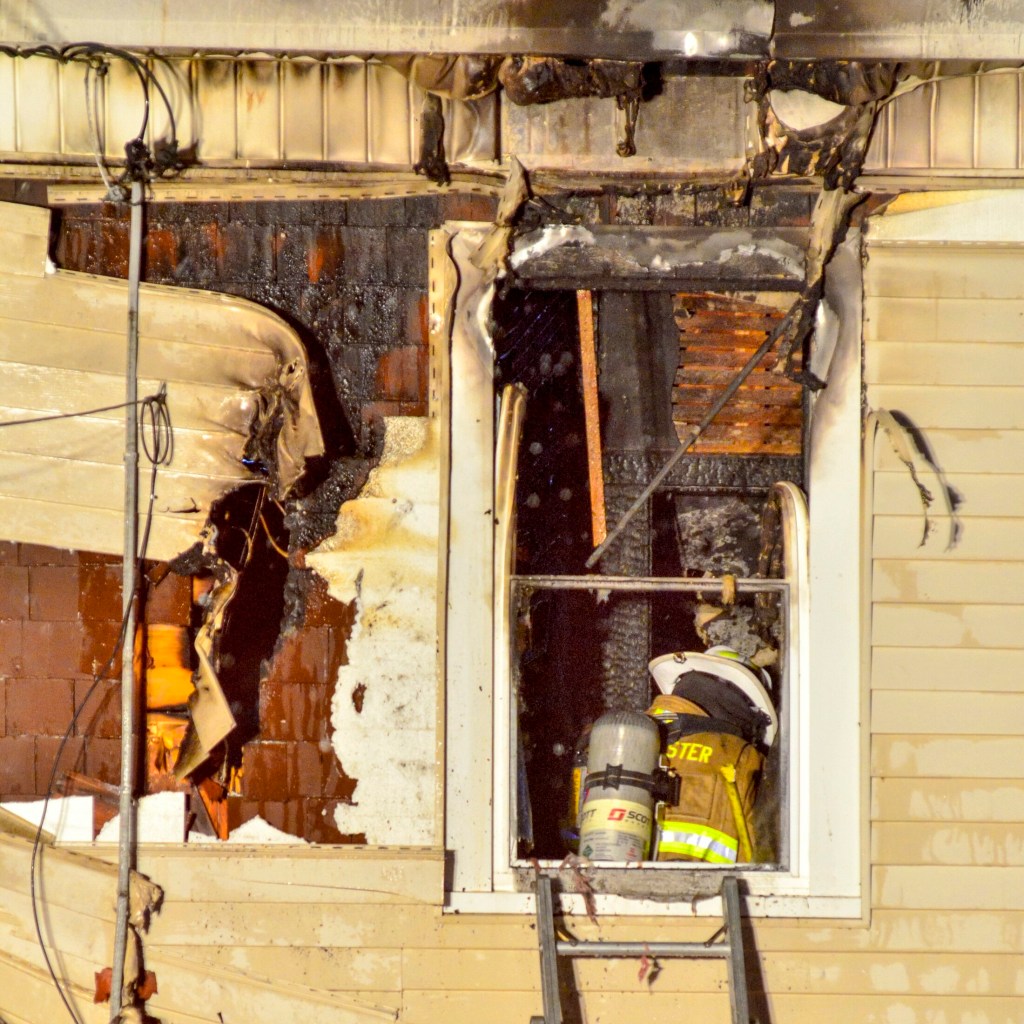 A firefighter inspects damage on the second floor at 6:07 p.m. after putting out a fire at 11 Densmore Court on Saturday in Hallowell. The fire was in a two-story residence at the end of Densmore Court, a short, dead-end street off Wilder Street, near Bolley's Famous Franks. The call came in at 4:24 p.m., and Augusta, Gardiner, Farmingdale and Randolph were some of the departments that responded as mutual aid. Water Street was closed between Winthrop and North streets.