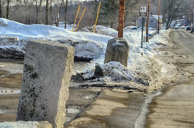 The stone blocks flanking the Lucky Garden restaurant parking lot driveway on March 6 in Hallowell. The state boat launch is seen in the background farther south on Water Street.