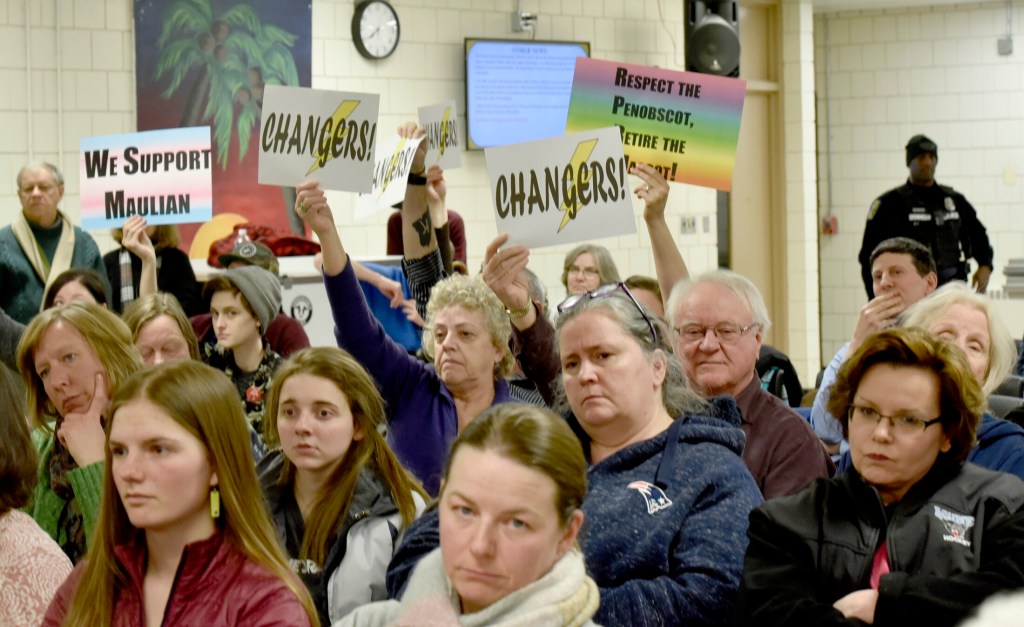 People against the use of the nickname Indian in SAD 54 schools hold signs urging school board members to vote to stop the practice during a meeting in Skowhegan on Thursday.