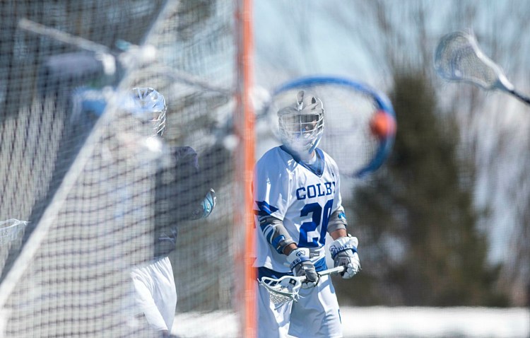 Colby College's CJ Hassan takes a shot on Connecticut College goalie Colin Smith on Saturday at Colby College.