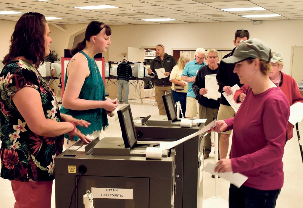 Winslow resident Michelle Dugal casts her ballot at the VFW on June 11 in the $8.1 million bond referendum to renovate the elementary and high schools and close the junior high. Rising construction costs have pushed the cost of renovations beyond the $8.1 million voters narrowly approved.