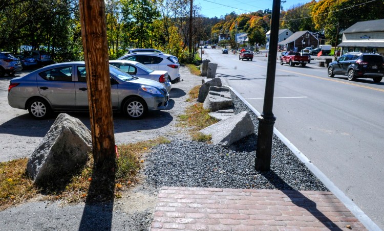 The new sidewalk ends at the boulders by the Lucky Garden restaurant parking lot, seen October 22, on Water Street in downtown Hallowell.