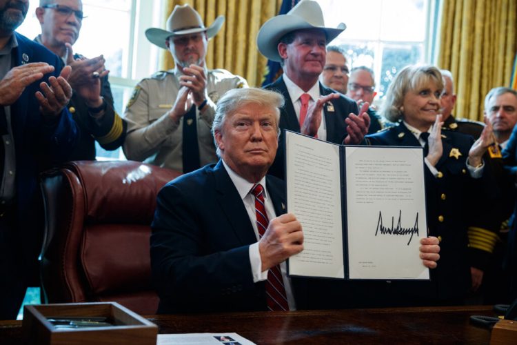 President Donald Trump signs the first veto of his presidency in the Oval Office of the White House, Friday, March 15, 2019, in Washington. Trump issued the first veto, overruling Congress to protect his emergency declaration for border wall funding. (AP Photo/Evan Vucci)