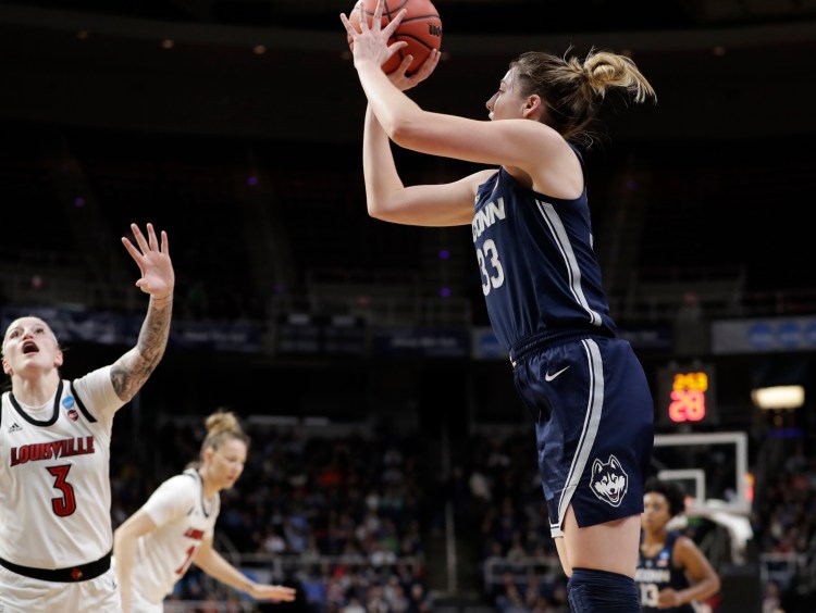 Louisville forward Sam Fuehring defends as UConn guard Katie Lou Samuelson takes a shot from the perimeter during the Huskies' 80-73 win on Sunday in Albany. UConn advances to its 12th straight Final Four with the victory.