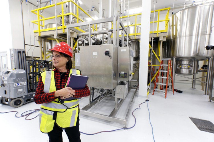 Betsy Williams, vice president of manufacturing operations at ImmuCell, gives a tour of the company's Portland facility on Evergreen Drive in 2017. The company's stock recently took a hit after one of its submissions to regulators for new product was rejected.