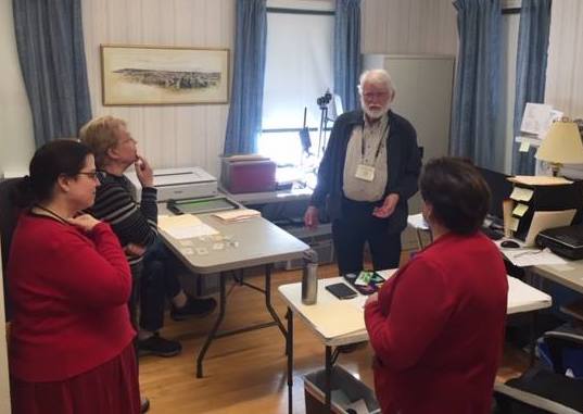 Ernest Plummer talks with volunteers during the Feb. 14 volunteer social at Kennebec Historical Society in Augusta.