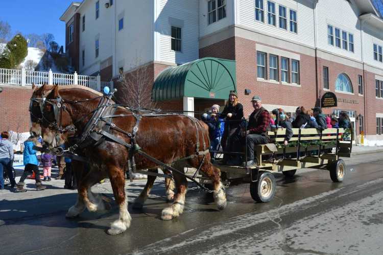 Kendric Charles, seated, is the horse driver during a previous Fire and Ice Festival in Farmington.